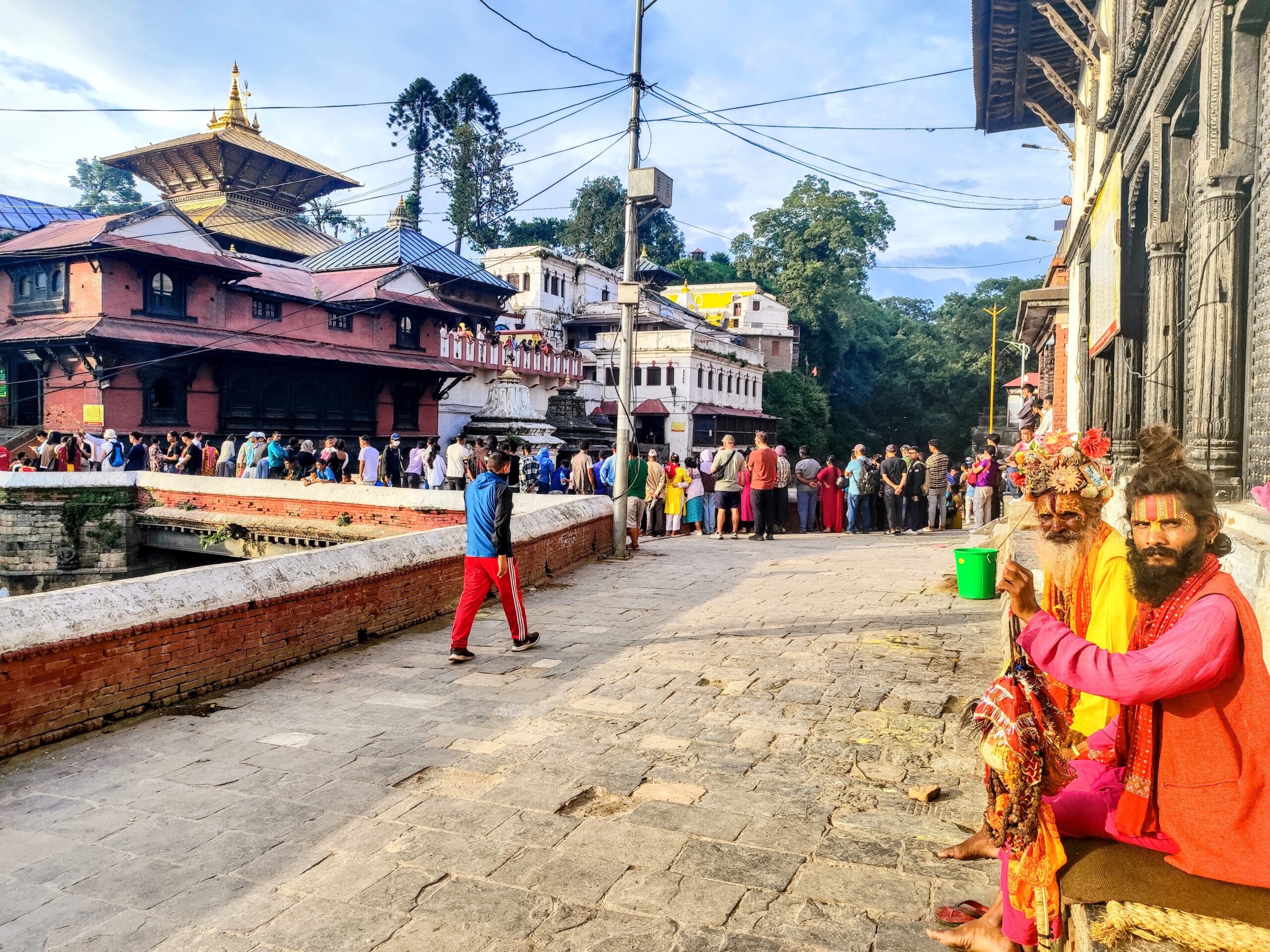Two colorful sadhus sitting in front of Pashupatinath Temple in Kathmandu, Nepal
