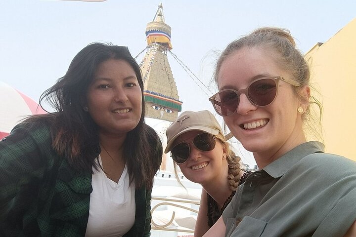 Female guide with two female travelers at a stupa in Kathmandu, Nepal